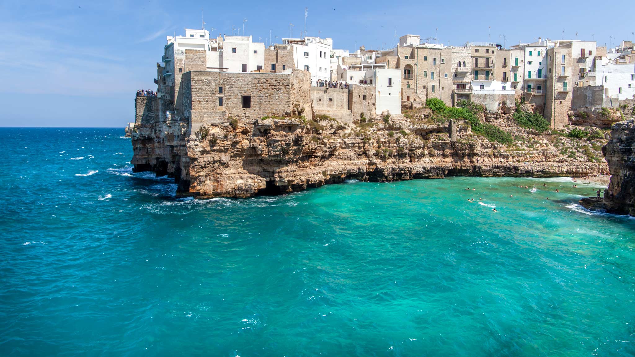 刷白悬崖建筑突出的蓝色海洋Polignano a母马