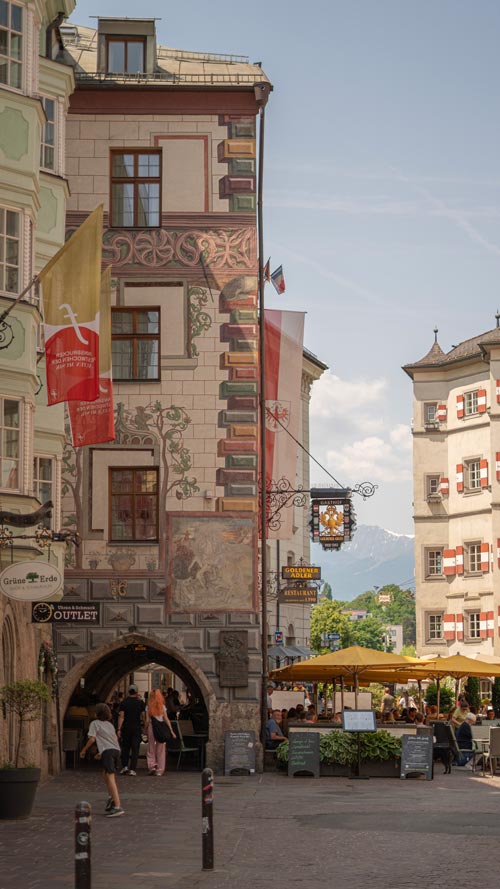 Views of Innsbruck Old Town in summer with brighly lit outside frescos