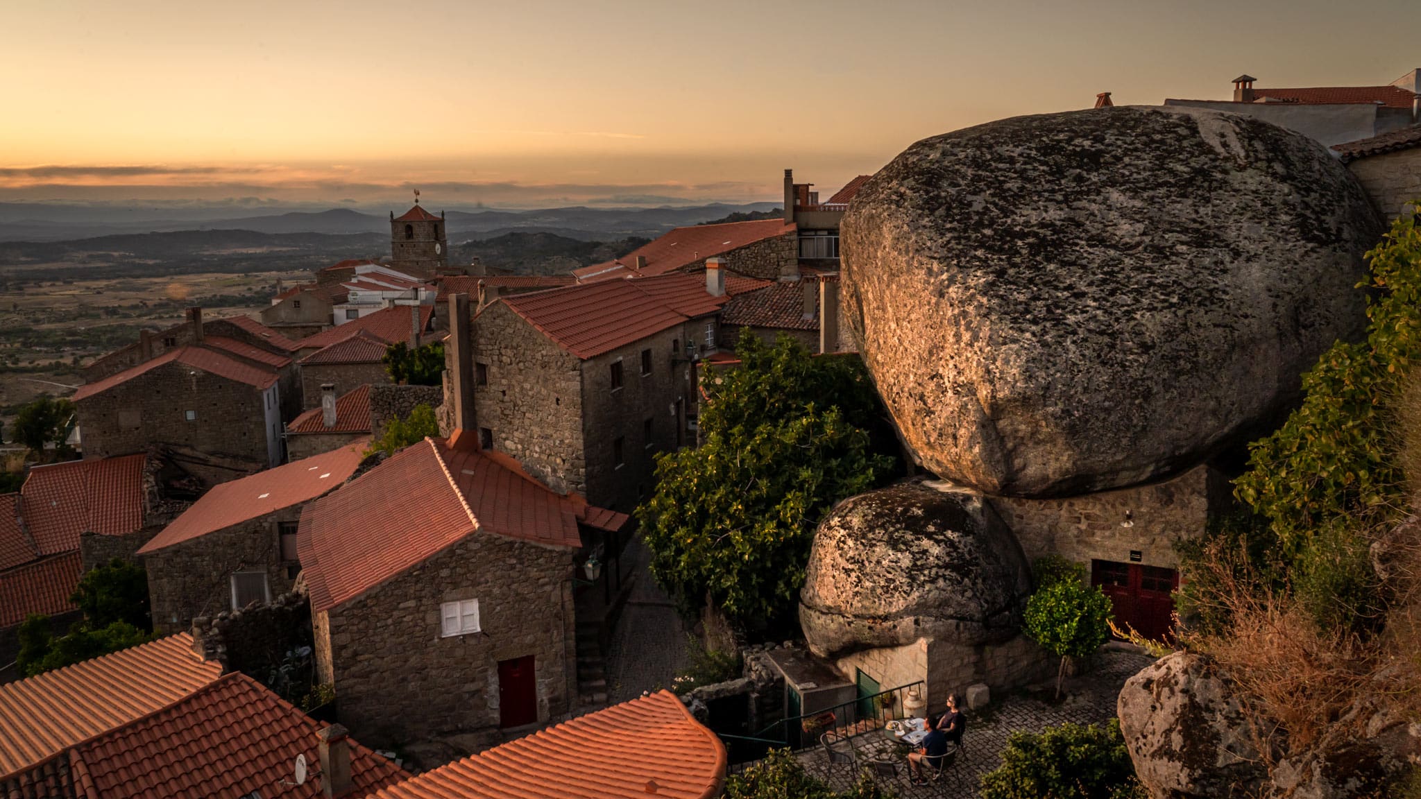 A giant boulder sits on top of a home in Monsanto, a Europe hidden gems In